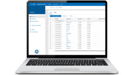 A laptop displays an invoicing dashboard with a list of draft invoices, showing columns for customer, document number, date, and other details.