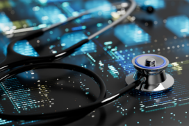 A stethoscope lies on a reflective surface displaying digital blue data patterns, symbolising the intersection of healthcare and technology.
