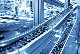 Close-up view of an automated conveyor belt system in a modern industrial manufacturing facility.