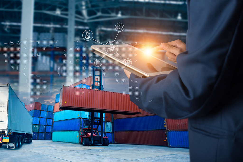 Person using a tablet in front of stacked shipping containers, with digital icons and a map overlay representing logistics and supply chain management.