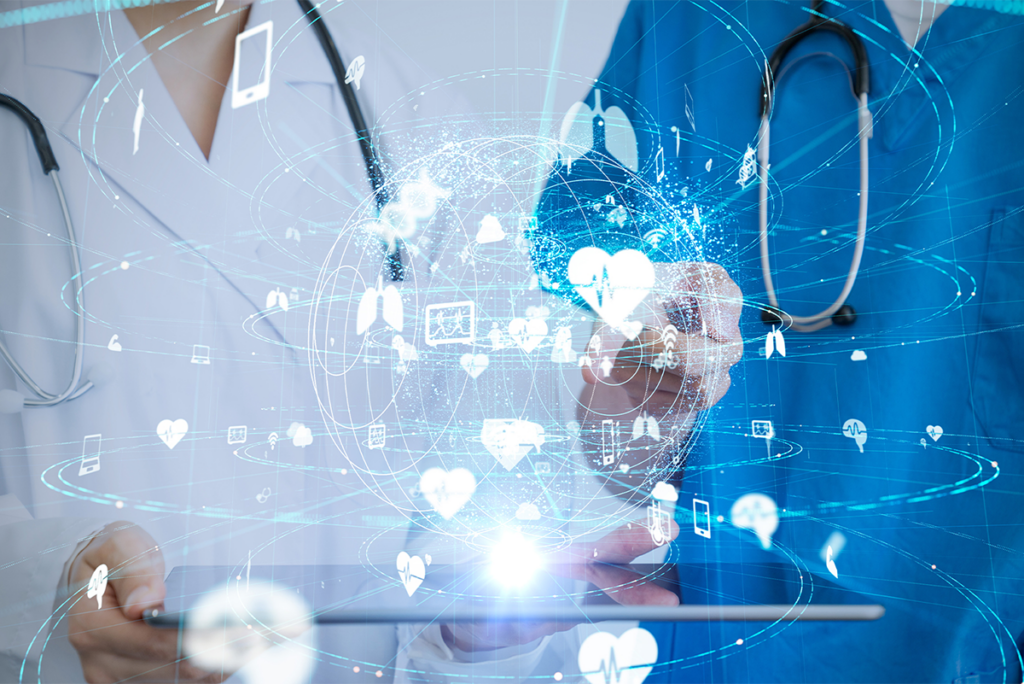 Two medical professionals interact with a digital tablet displaying health-related icons and network graphics, suggesting the use of technology in healthcare.